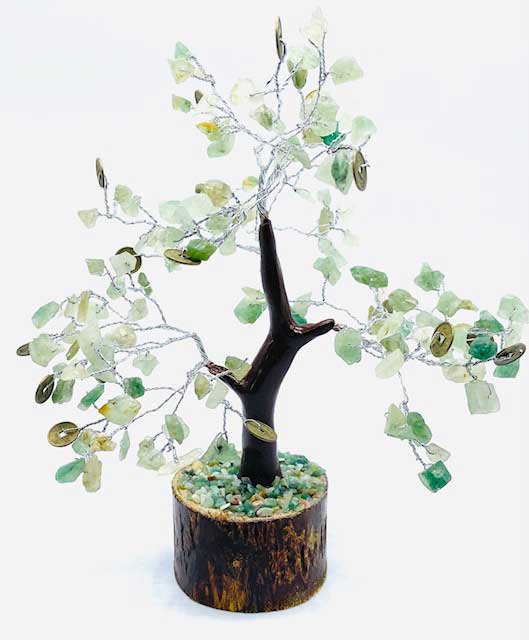 Decorative tree with green beads on a white background