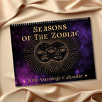 2026 Astrology Calendar titled 'Seasons of the Zodiac' on a purple fabric background