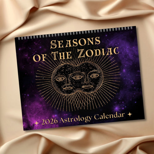 2026 Astrology Calendar titled 'Seasons of the Zodiac' on a purple fabric background
