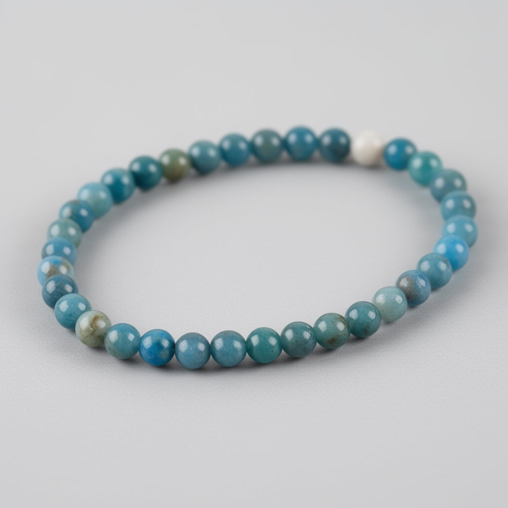 Blue beaded bracelet on a light gray background