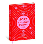 A hardcover astrology planner titled '2027 Astrology Planner' by Patsy Bennett, featuring a bright red cover with pink orbital rings, celestial illustrations, and white text, shown standing upright on a white background.