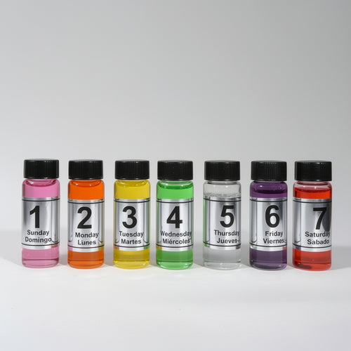 Seven bottles with colorful labels indicating days of the week on a white background