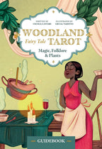 Cover of 'Woodland Fairy Tale Tarot' with a woman in a pink dress and apron at a table with plants and a pot.