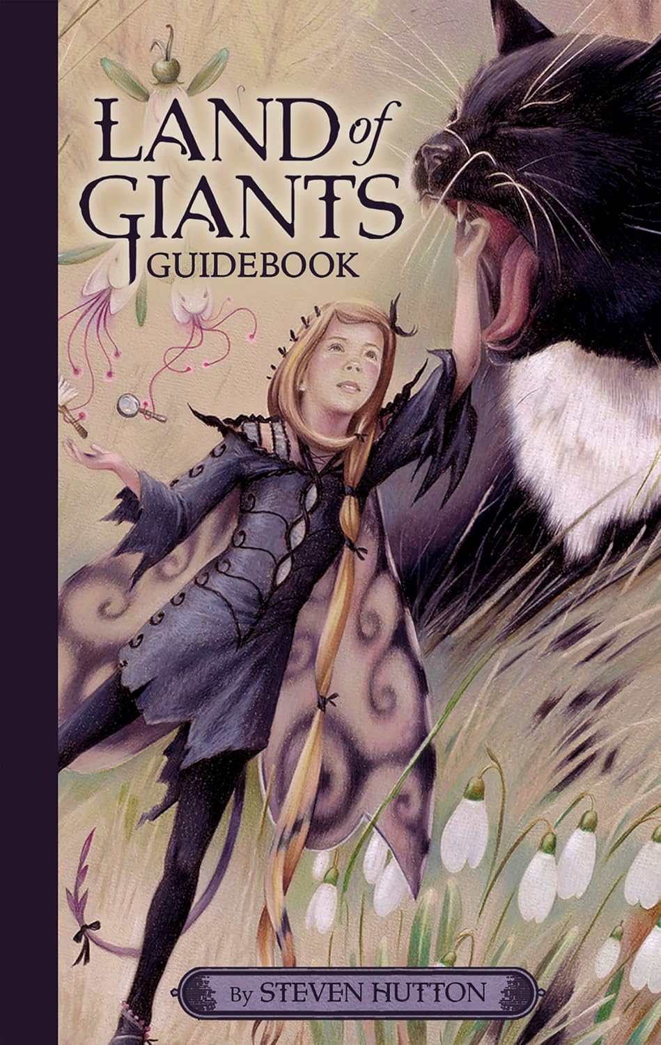Book cover of 'Land of Giants Guidebook' featuring a person and a giant cat with a fantasy design.