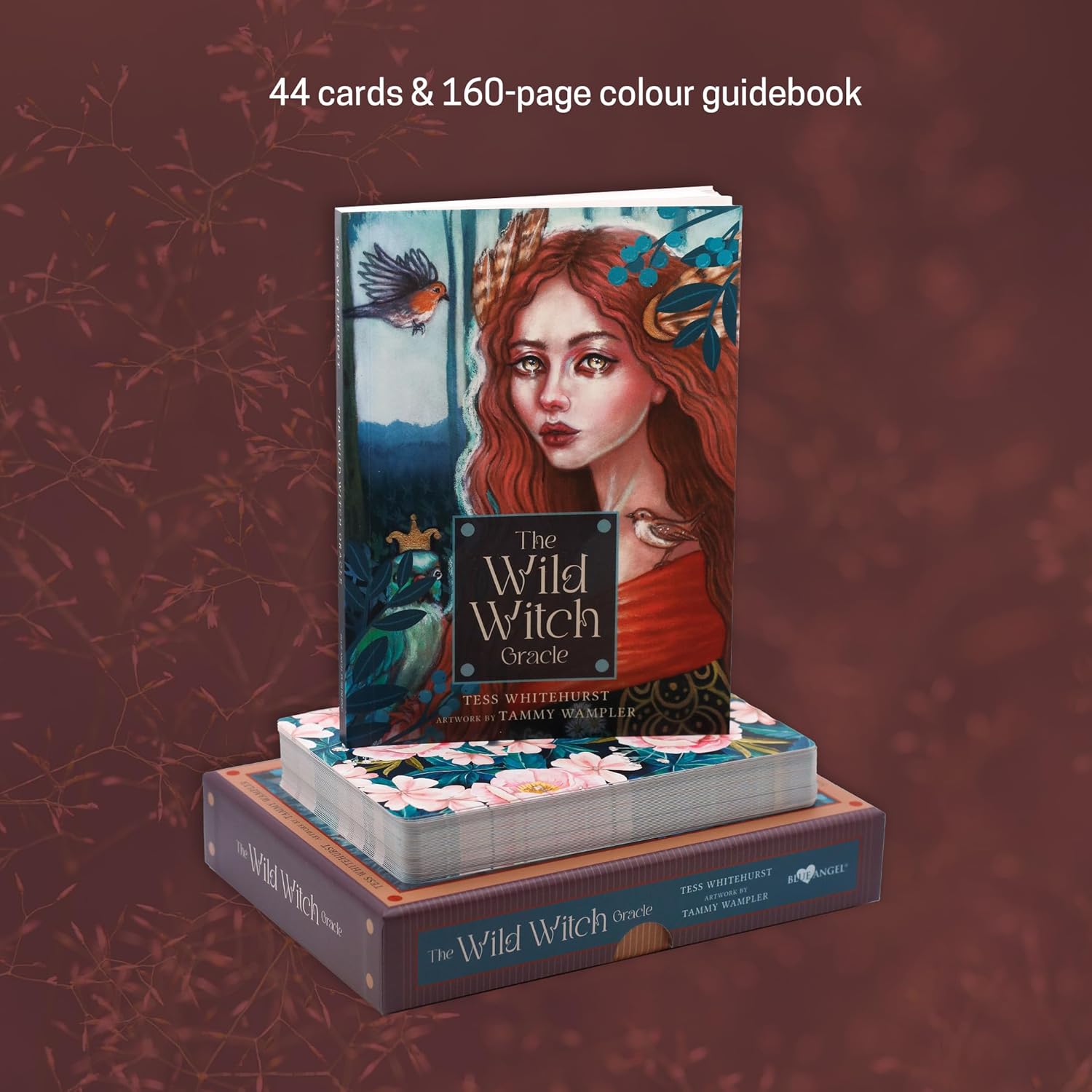 The Wild Witch Oracle card set with packaging on a dark red background