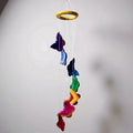 Colorful butterfly-shaped wind chime hanging against a plain background