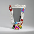 Decorative mirror with colorful frame and base featuring a mushroom, flower, and butterfly on a gray background.