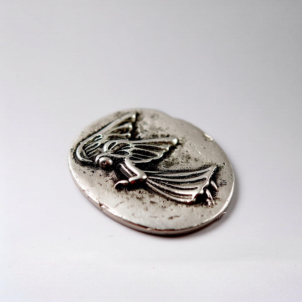 A pocket stone with angel design on a white background
