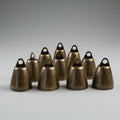 Bronze colored bells arranged on a gray background