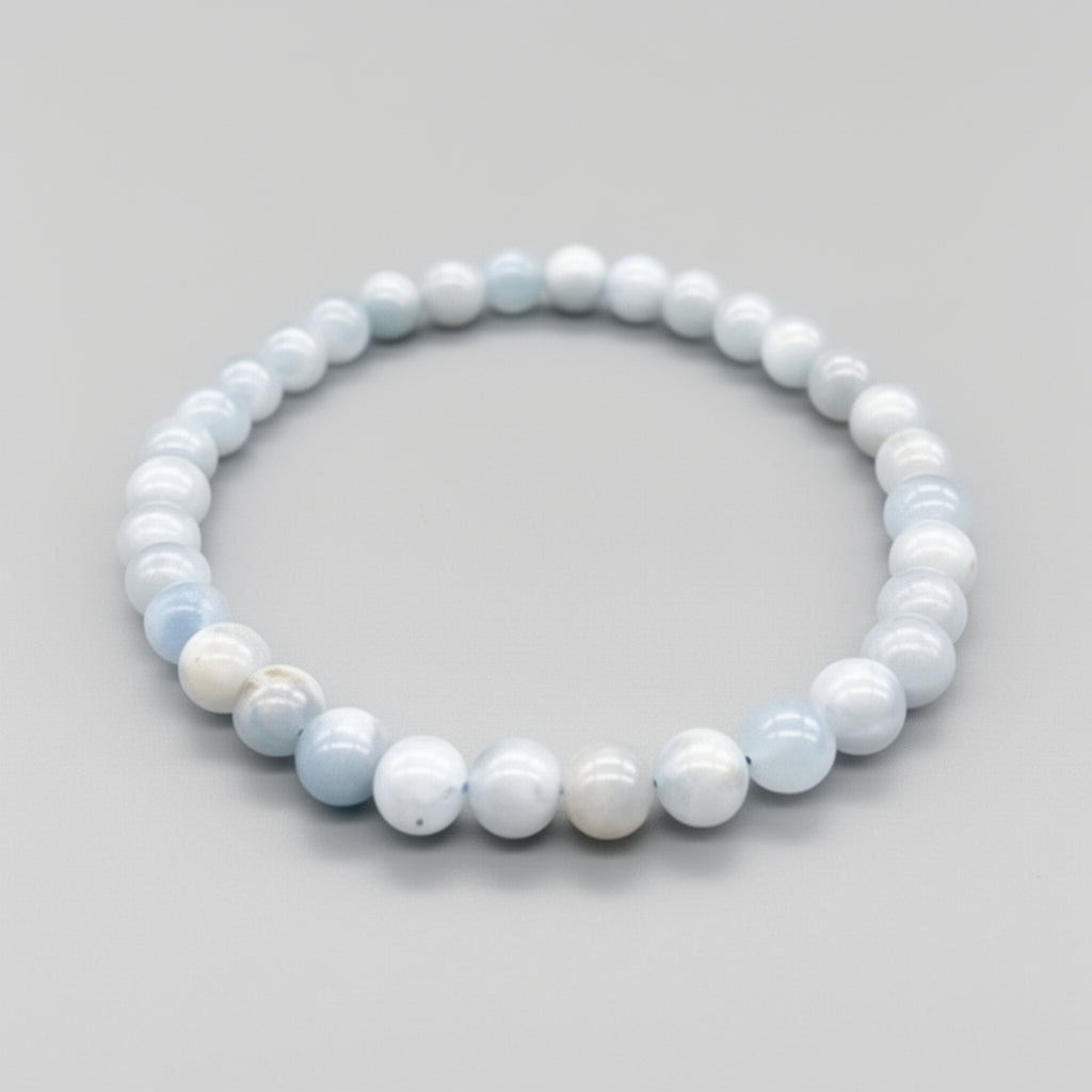 Beaded bracelet with light blue and white beads on a gray background