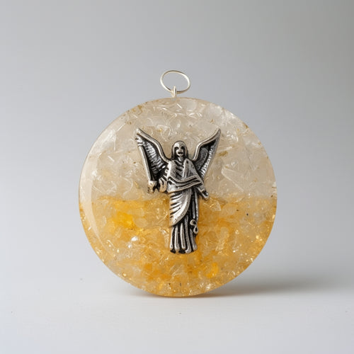 Round pendant with angelic design on a textured beige and orange stone background