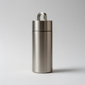 Stainless steel container with a lid on a light gray background