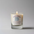 Candle with a label reading 'Astral Journey" on a gray background