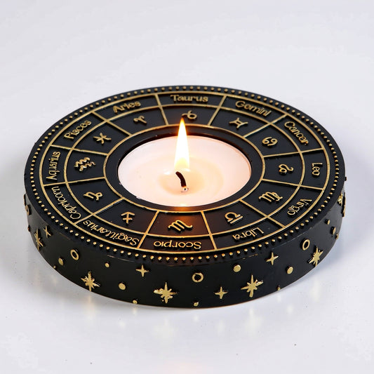 Decorative candle holder with zodiac symbols on a white background