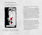 A printed page from a book or booklet titled 'THE HANGED WOMAN' with a black-and-white illustration of a woman hanging from a cross, a red heart, and small text including 'YES', 'NO', 'MAYBE', and notes about patience, delay, surrender, and self-pity.