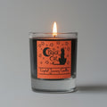 Candle with a 'Black Cat' label on a gray background