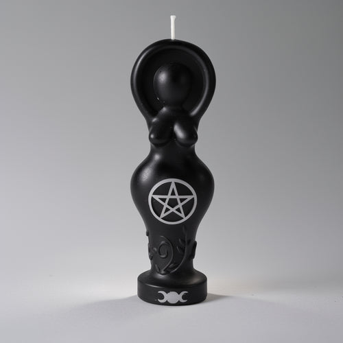 Black candle shaped like a female figure with a pentagram symbol on a gray background