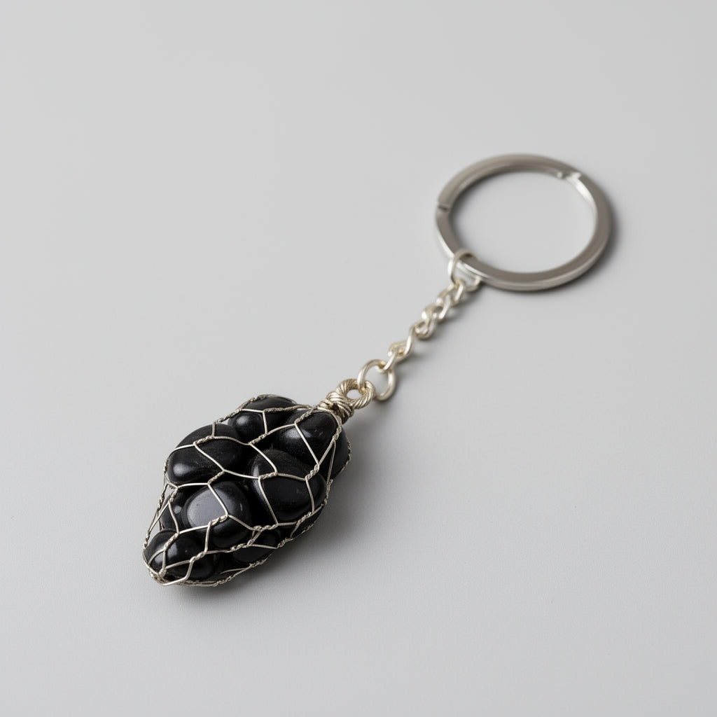 Keychain with a black stone pendant on a gray background