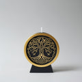 Decorative candle with intricate design on a gray background