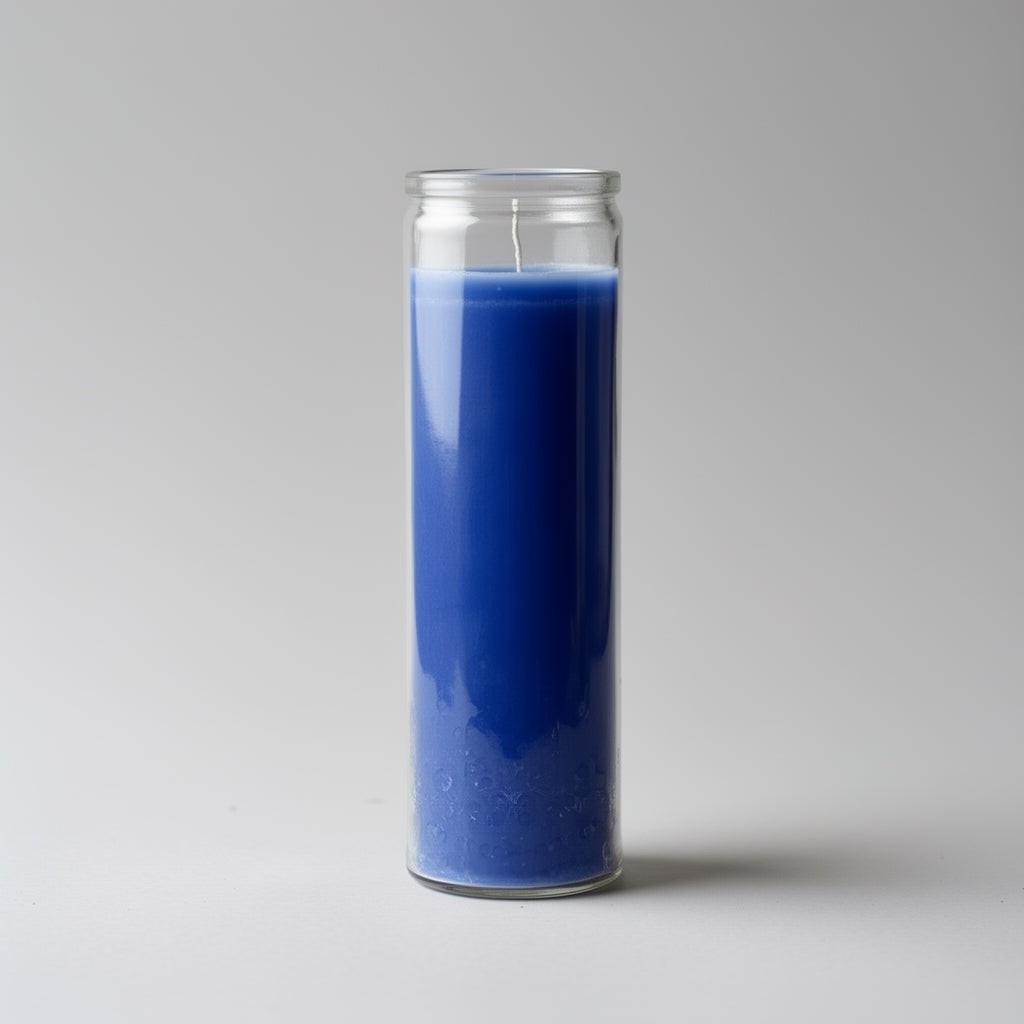 Blue candle in a clear glass jar on a gray background