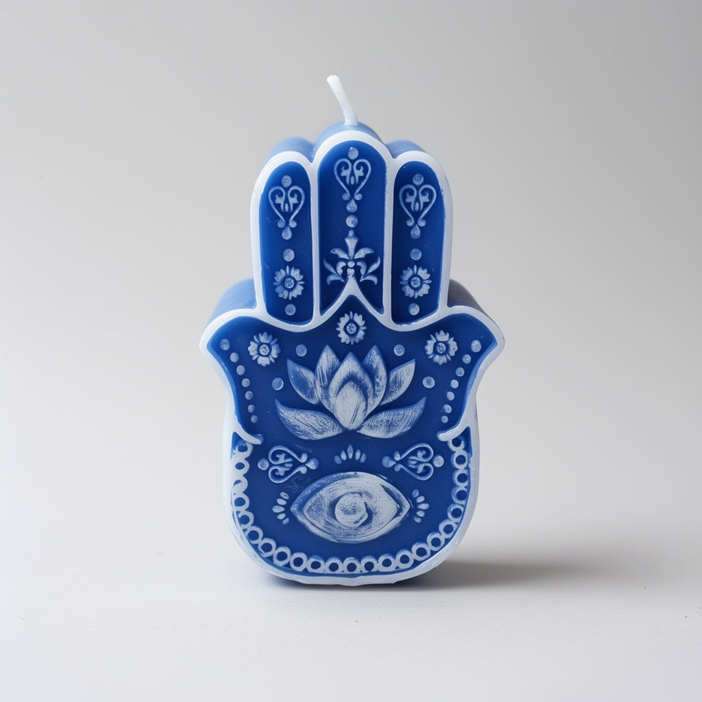 Blue Hamsa hand candle with intricate designs on a gray background