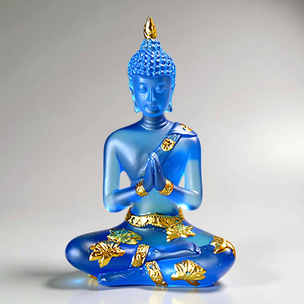 Blue Buddha statue with gold accents on a gray background