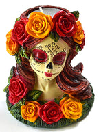 Decorative tealight holder of woman with a painted skull face with colorful roses on a white background.