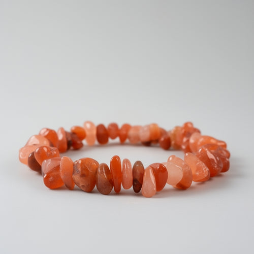 Orange and pink stone bracelet on a gray background
