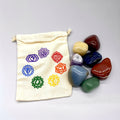 Set of chakra stones with a drawstring bag featuring chakra symbols on a white background