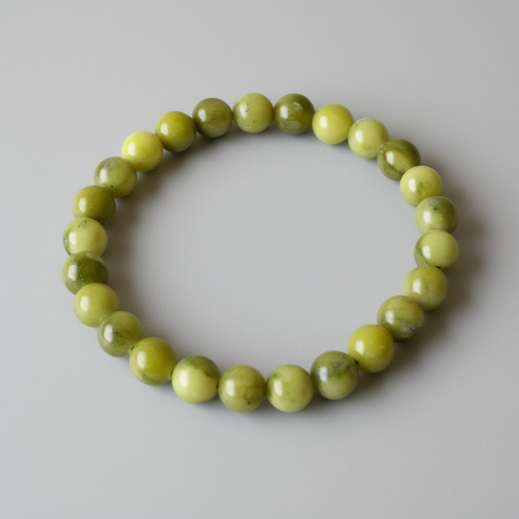 Green beaded bracelet on a light gray background