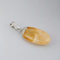 Pendant with a yellow stone and silver setting on a gray background