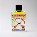 Bottle of 'Clean Sweep' spiritual oil with a broom and ribbon design on the label against a white background.