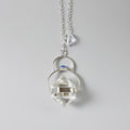 Crystal pendant necklace on a gray background