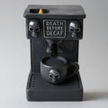 Black coffee machine shaped incense burner with skull designs and 'Death Before Decaf' text on a gray background