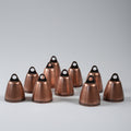 Set of copper bells on a gray background