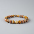 Beaded bracelet with multicolored stones on a light gray background