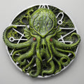 Green octopus-like creature with red eyes on a circular emblem with clock hands.