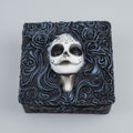Decorative box with a skull design and floral patterns on a white background