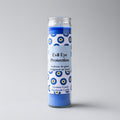 Candle with 'Evil Eye Protection' label on a gray background
