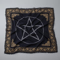 Black cloth with white pentagram design and gold border on a gray background