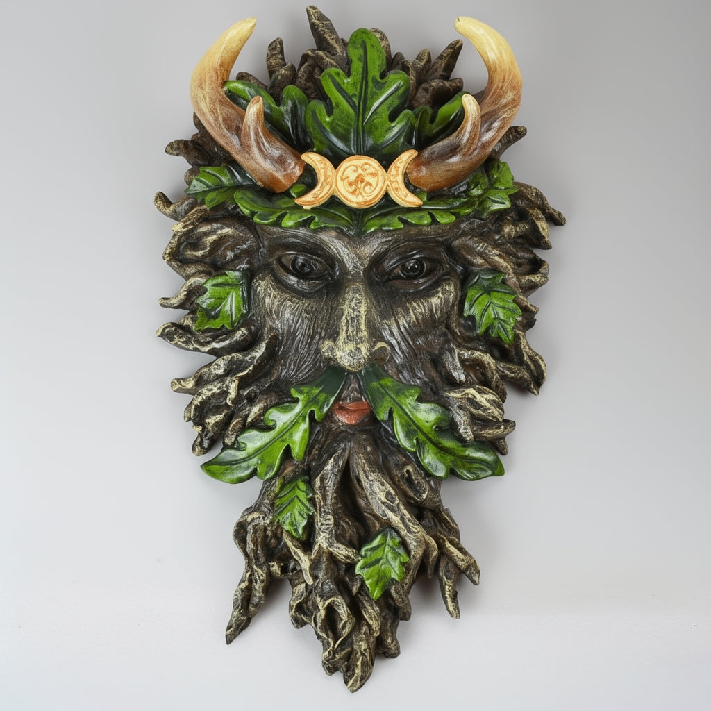 Decorative wall piece with green face, leaves, and horns on a white background