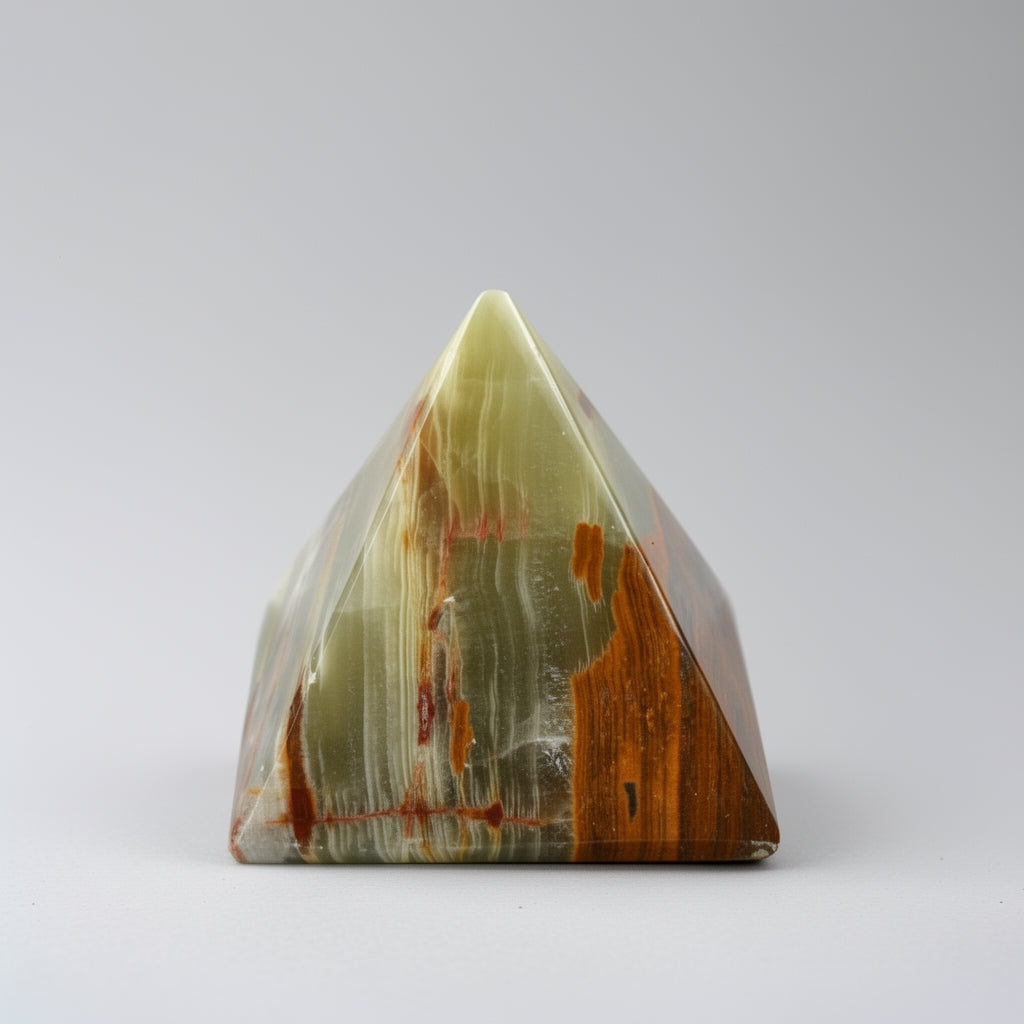 Triangular pyramid-shaped stone with brown and green patterns on a white background