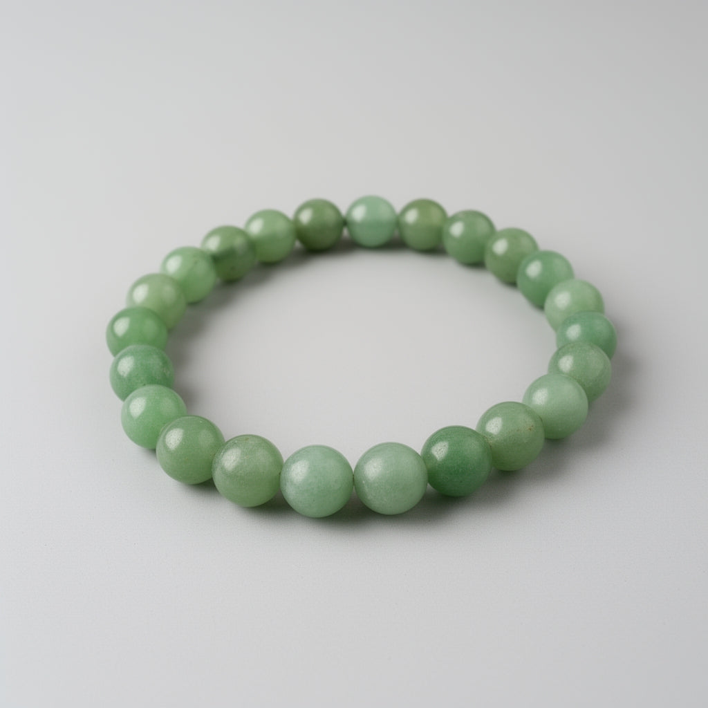 Green beaded bracelet on a light gray background