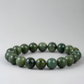 Beaded bracelet with green beads on a white background