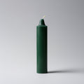 Green candle on a gray background