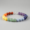 Colorful beaded bracelet with a rainbow pattern on a white background