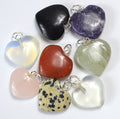 Collection of heart-shaped stone pendants on a white background