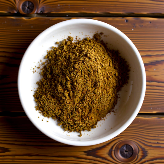 White bowl filled with brown powder on a wooden surface