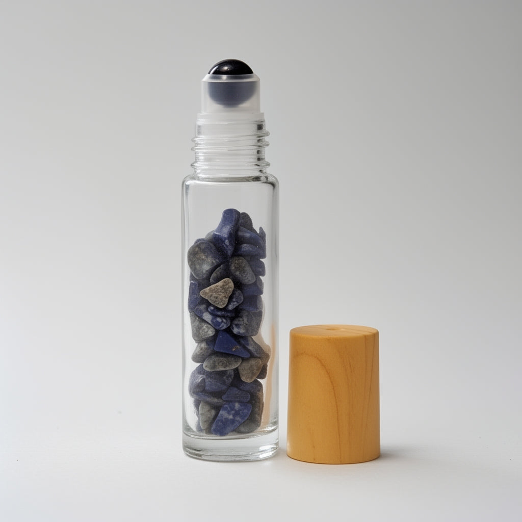 Glass roller bottle with wooden cap and stones inside on a white background