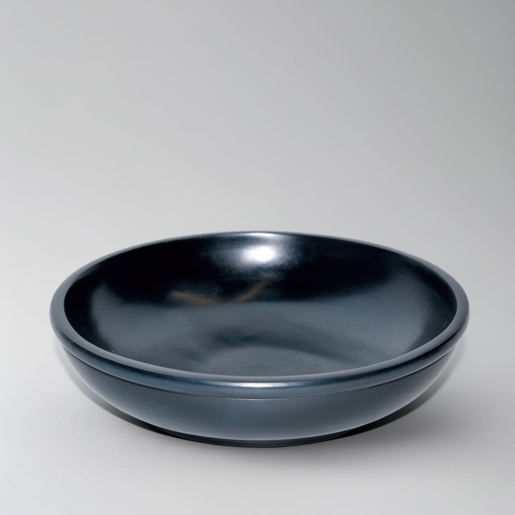 Black ceramic bowl on a light gray background
